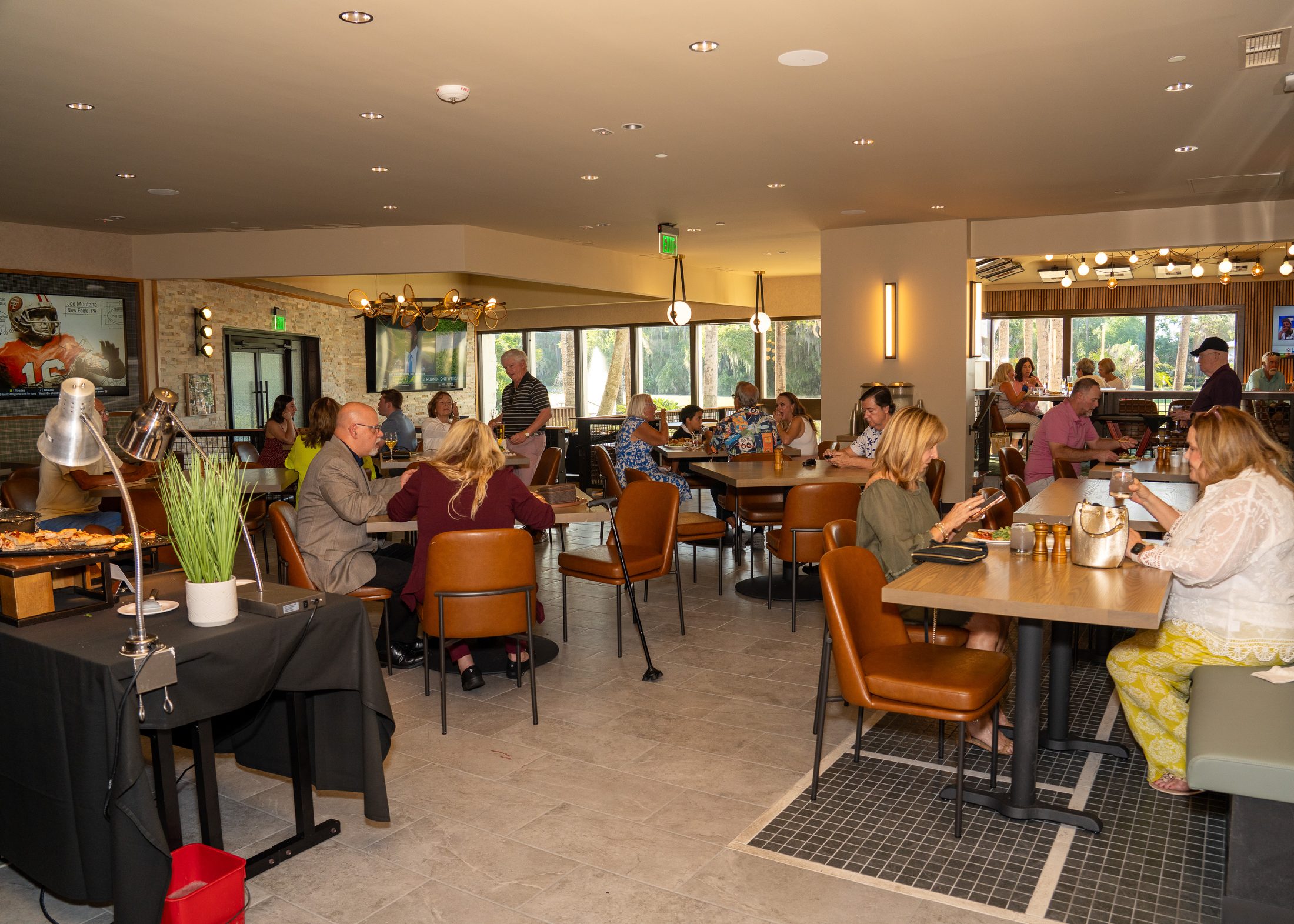 Restaurant venue room filled with guests, service, and warm architectural detail